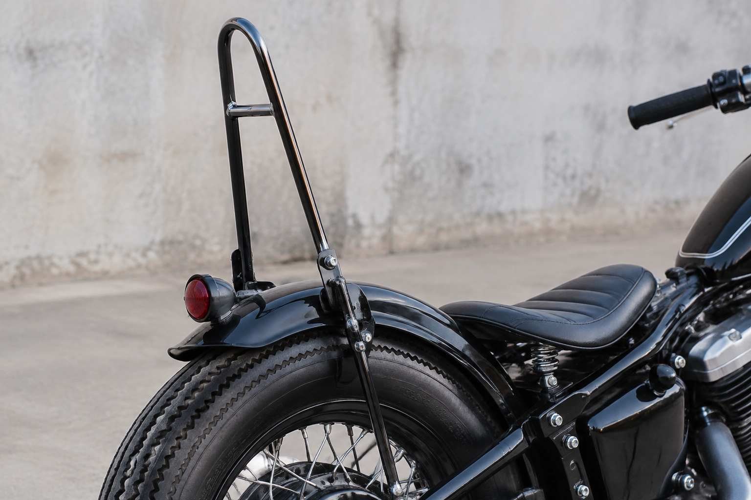 Custom sissy bar mounted on a bobber rear fender