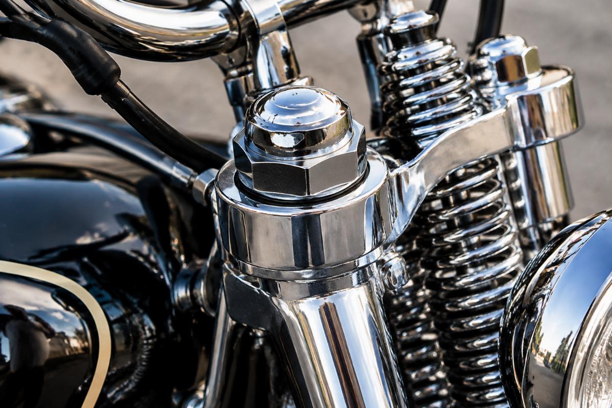 Chrome spring fork stem nut motorcycle aftermarket close-up view