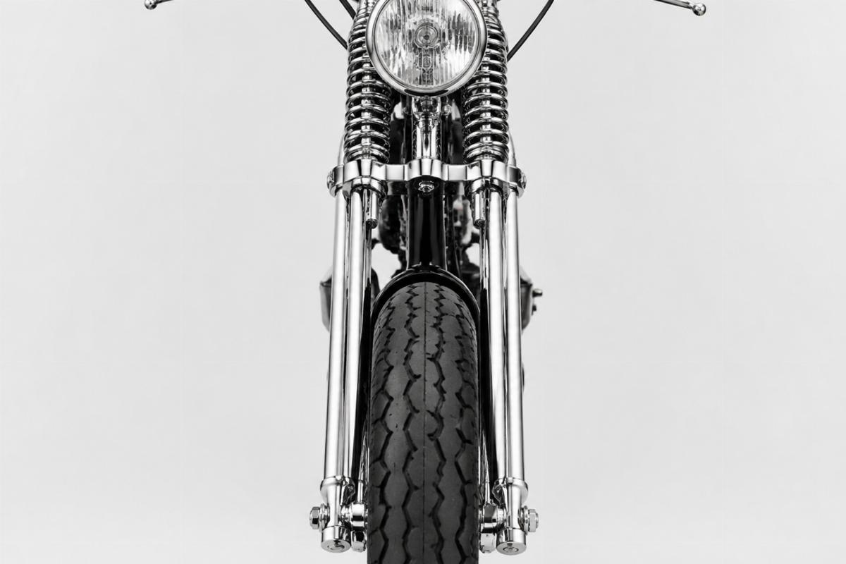 Chrome spring fork with rods motorcycle aftermarket front view showing finish