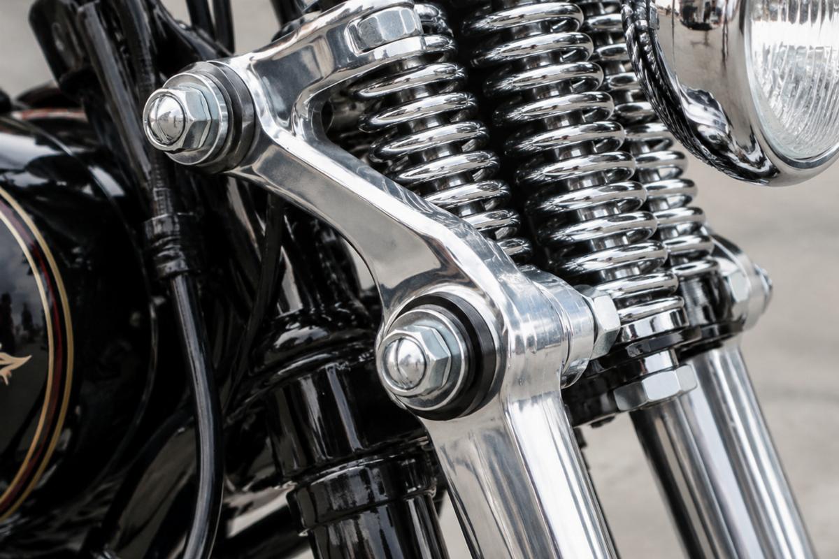 Close up detail of chrome spring fork rocker set mounting points and hardware