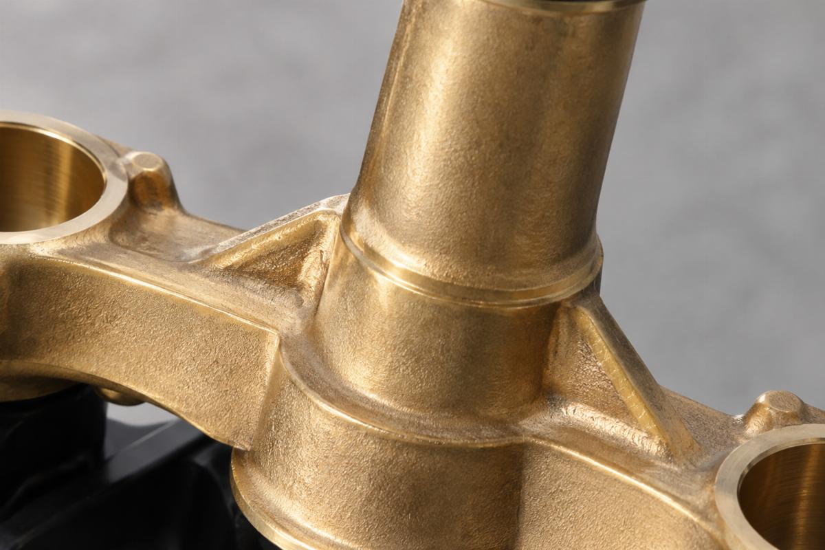 Close up detail of the cast brass steering stem and natural construction finish