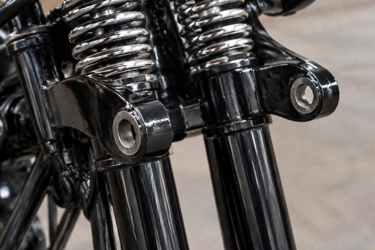 Close up of 1/2 inch rocker stud holes on black springer fork