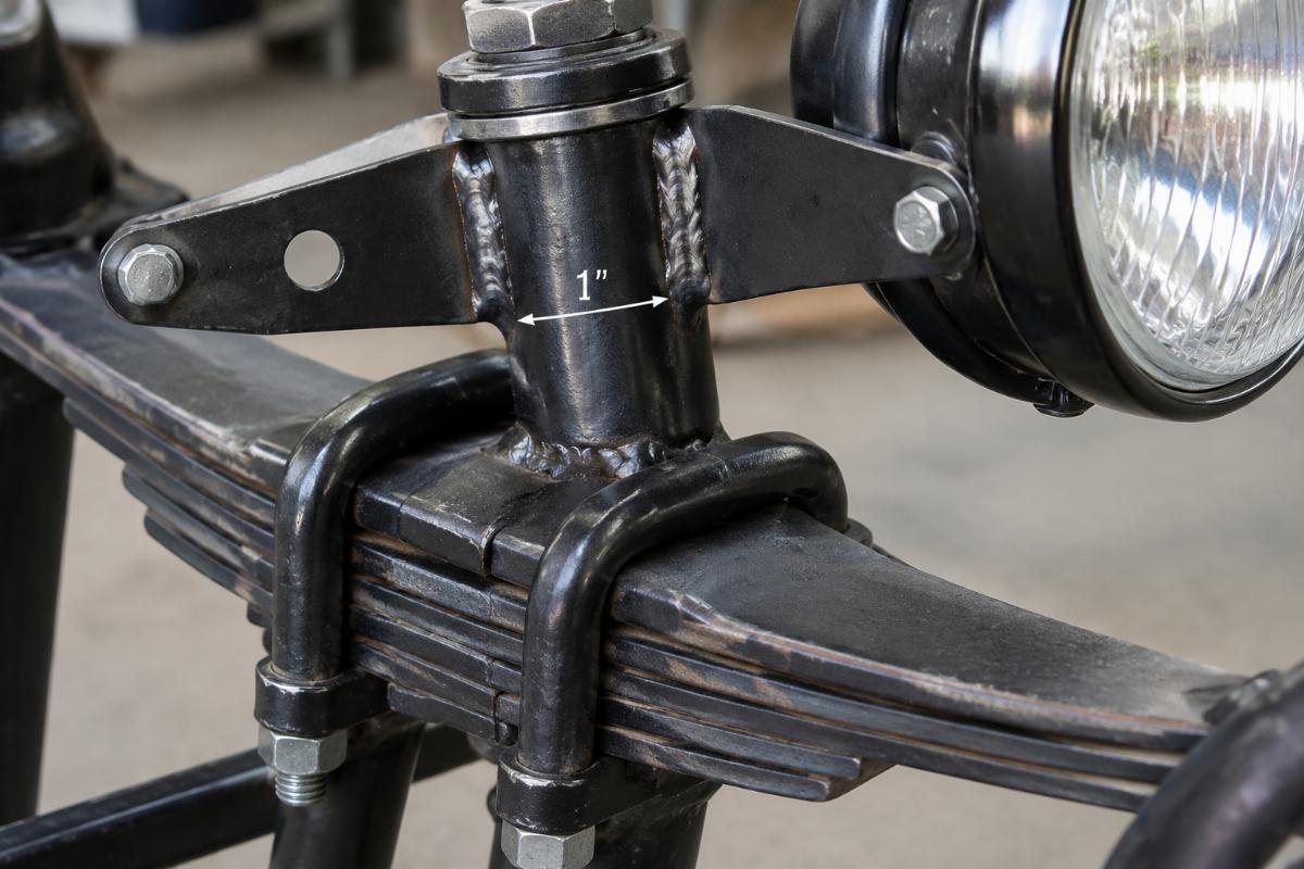 Close up of 1 inch stem and welded headlamp brackets on leaf spring fork assembly