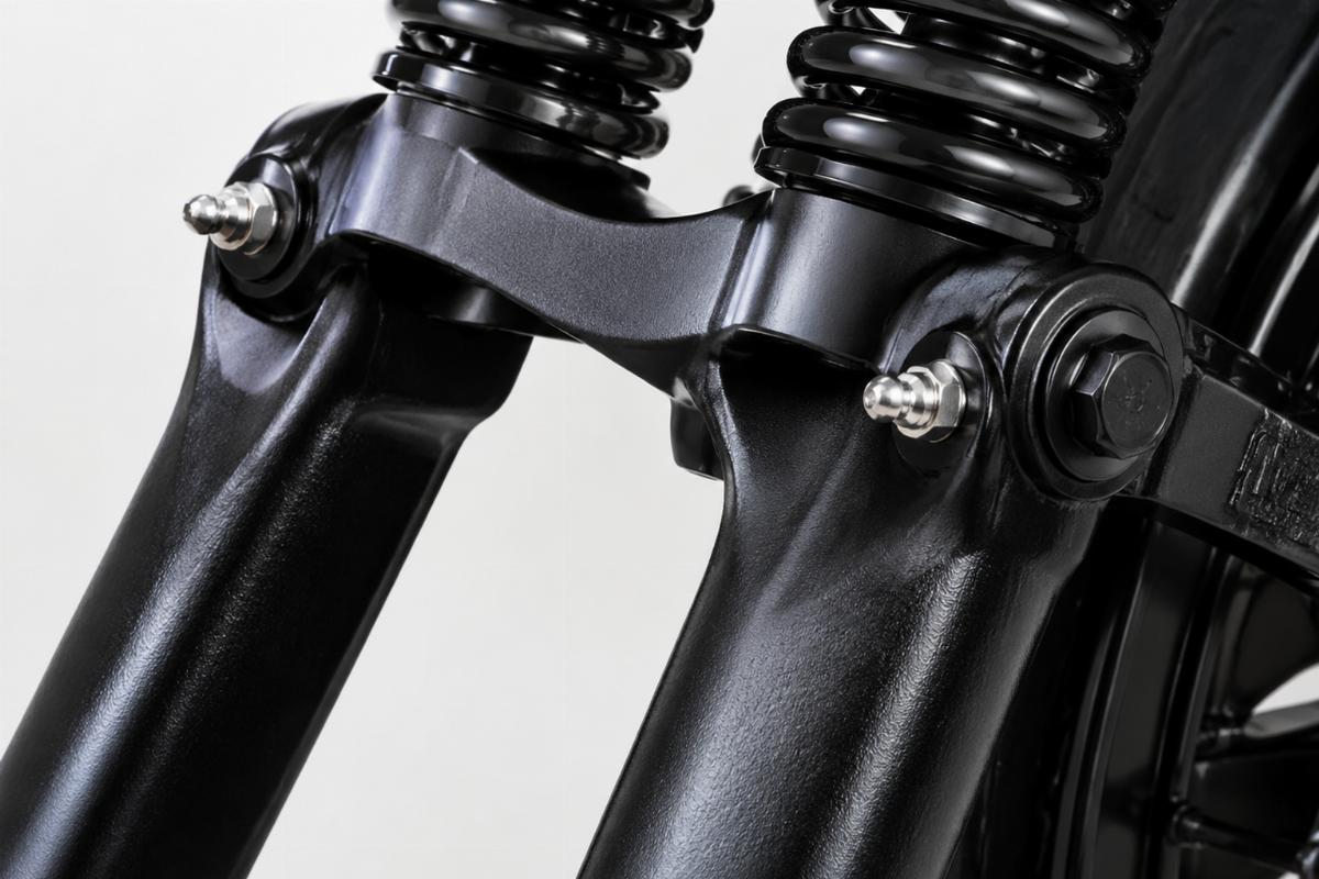 Close up of 1-piece rear legs and rocker grease fittings on black powder coat springer