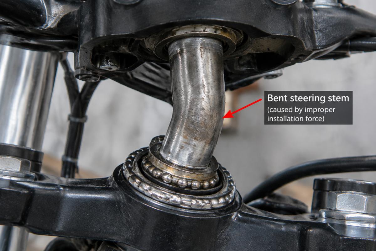 Close-up of a bent steering stem caused by improper installation force