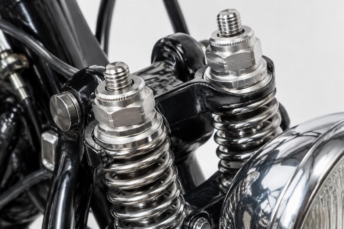 Close-up of adjustable spring preload nuts on a springer fork assembly