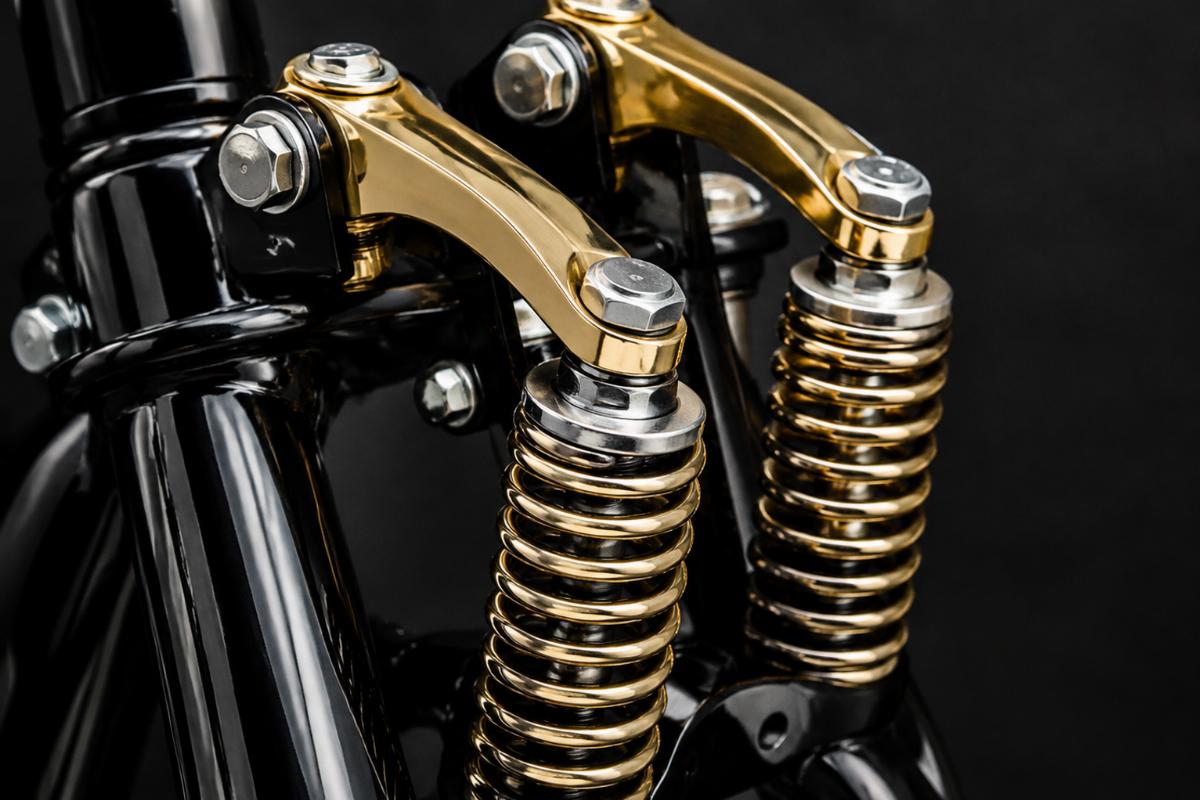 close up of brass plated rockers and springs on black 28 inch springer fork kit