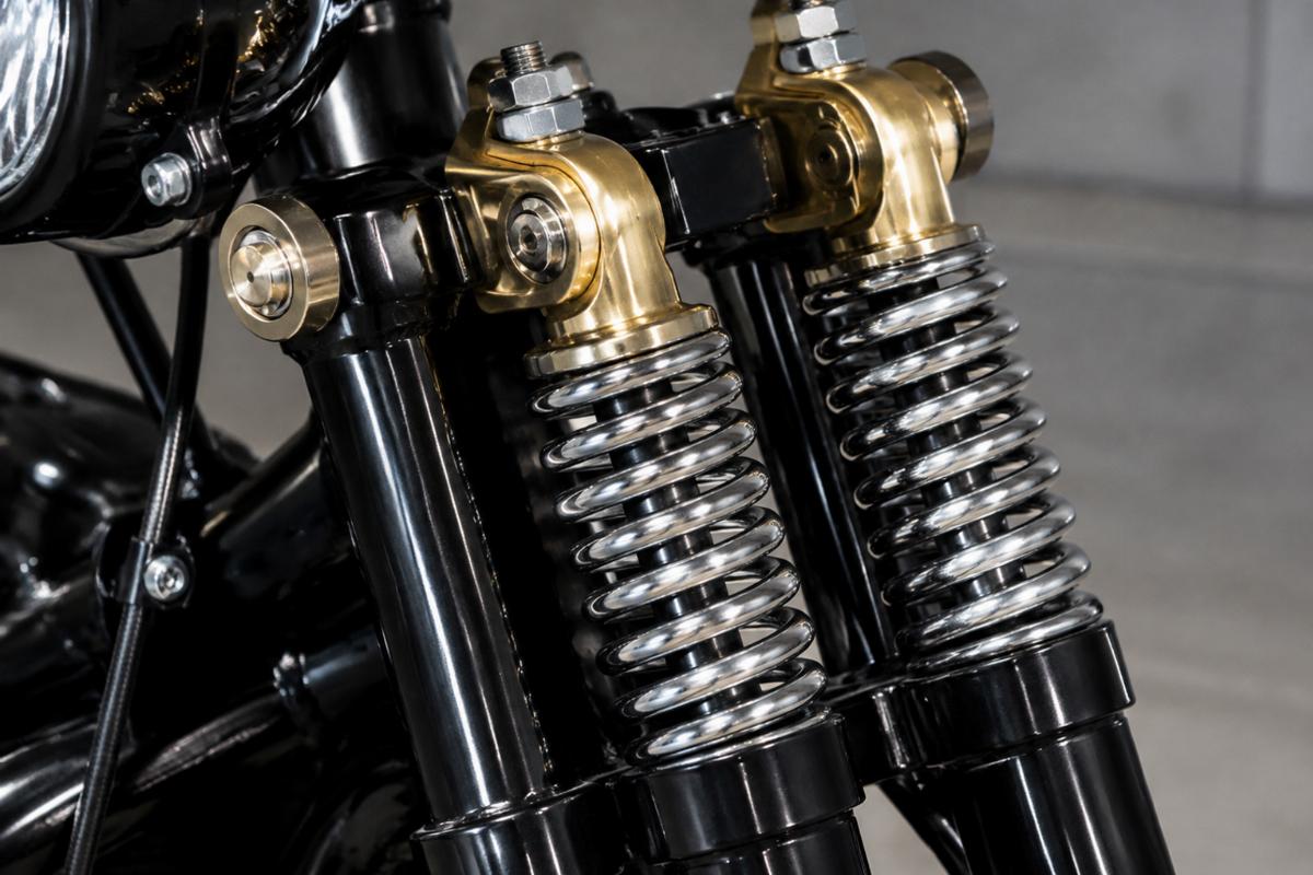 Close up of brass plated rockers and springs on black custom springer fork kit