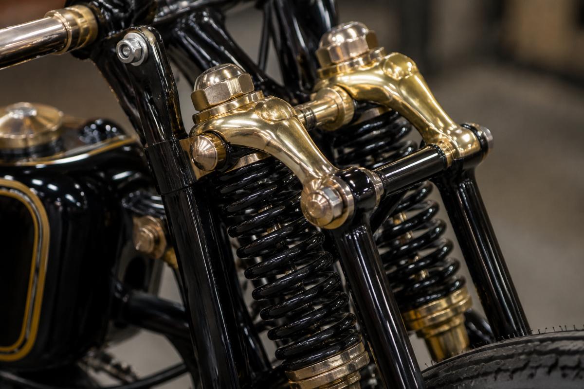 Close up of brass plated rockers and springs on black springer fork