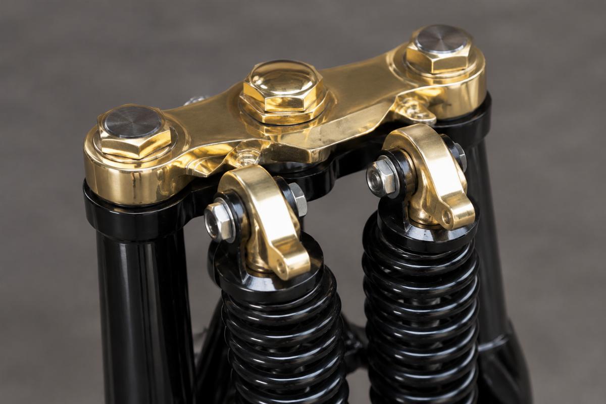 Close up of brass plated top tree and rockers on black spring fork kit
