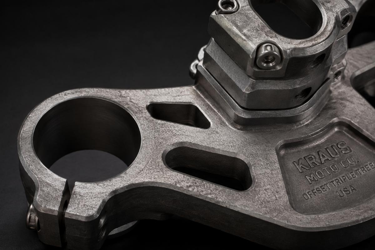 Close up of cable routing holes and raw forging finish on offset triple tree