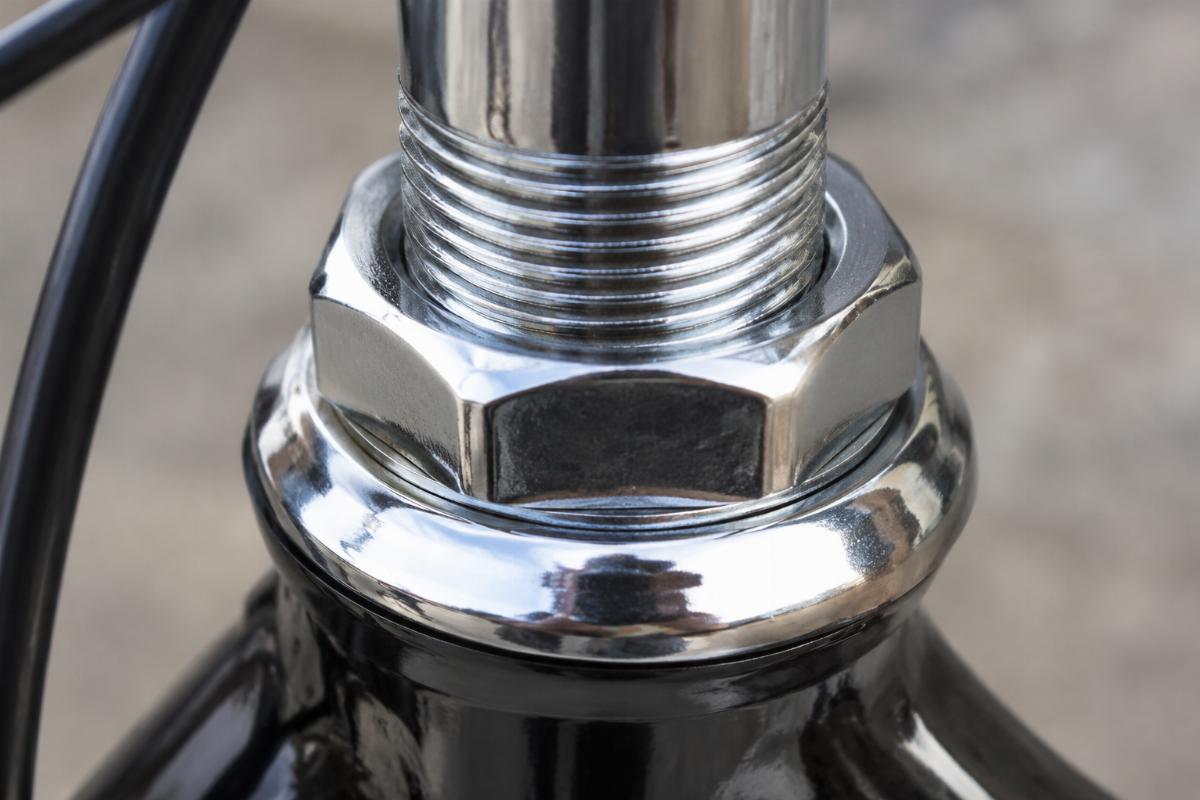 Close up of chrome plated threads on fork stem nut