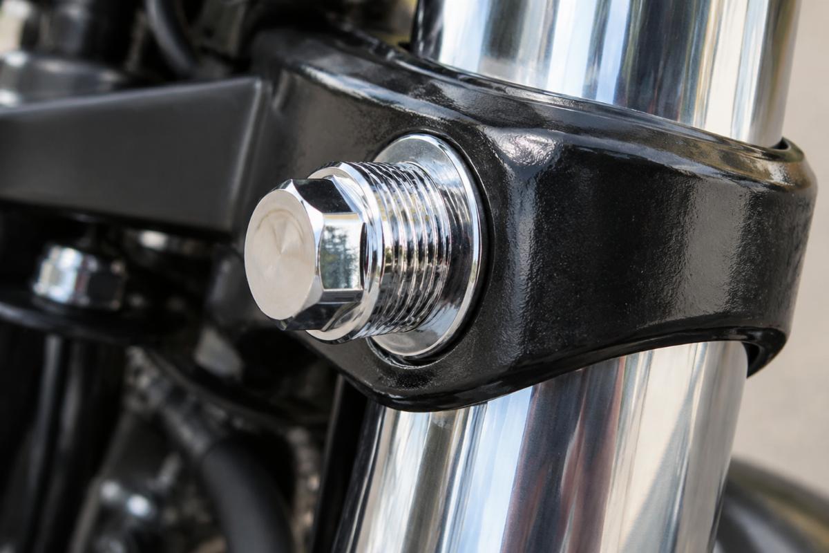 Close up of chrome plated threads on fork tube upper bracket bolt