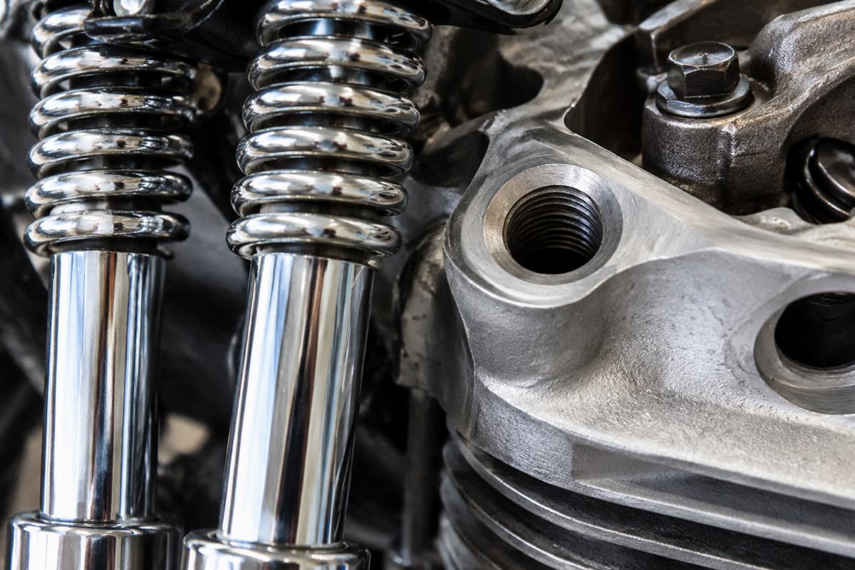Close up of chrome spring fork rods and 1/2 inch rocker stud hole detail