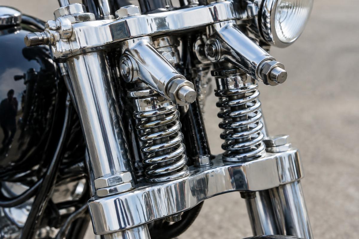 Close up of chrome triple trees and rocker studs on inline spring fork