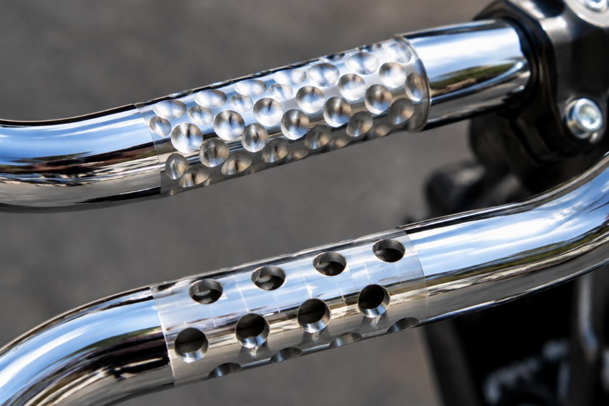 Close up of dimpled and drilled sections on chrome handlebars