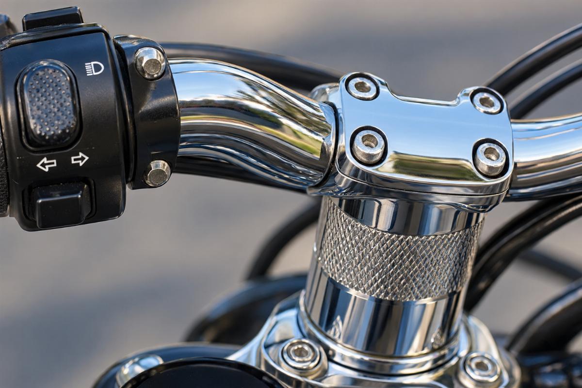 Close up of dimpled switch area and knurled riser center on chrome handlebars