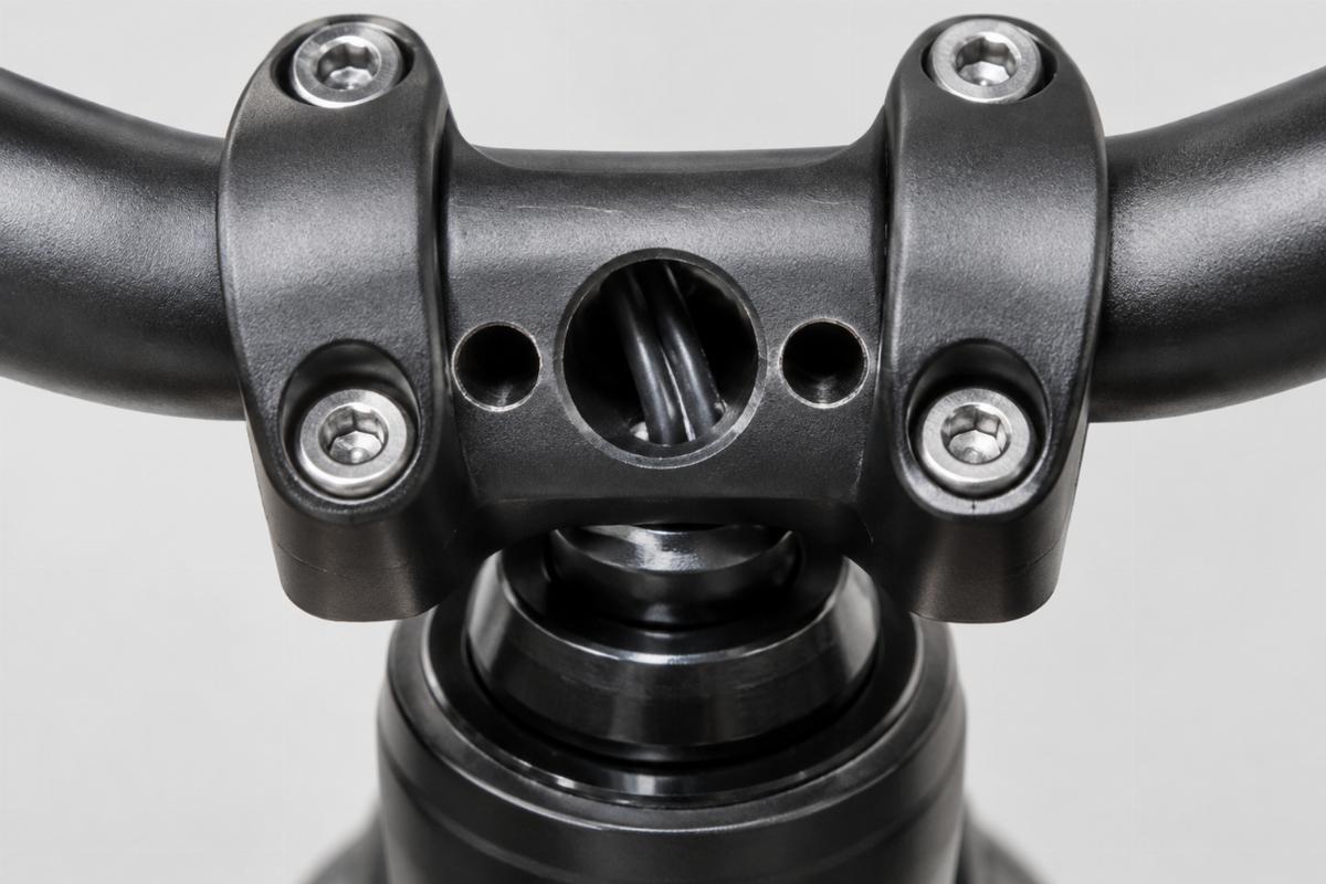 Close up of drilled holes for internal wiring on the center section of the handlebars