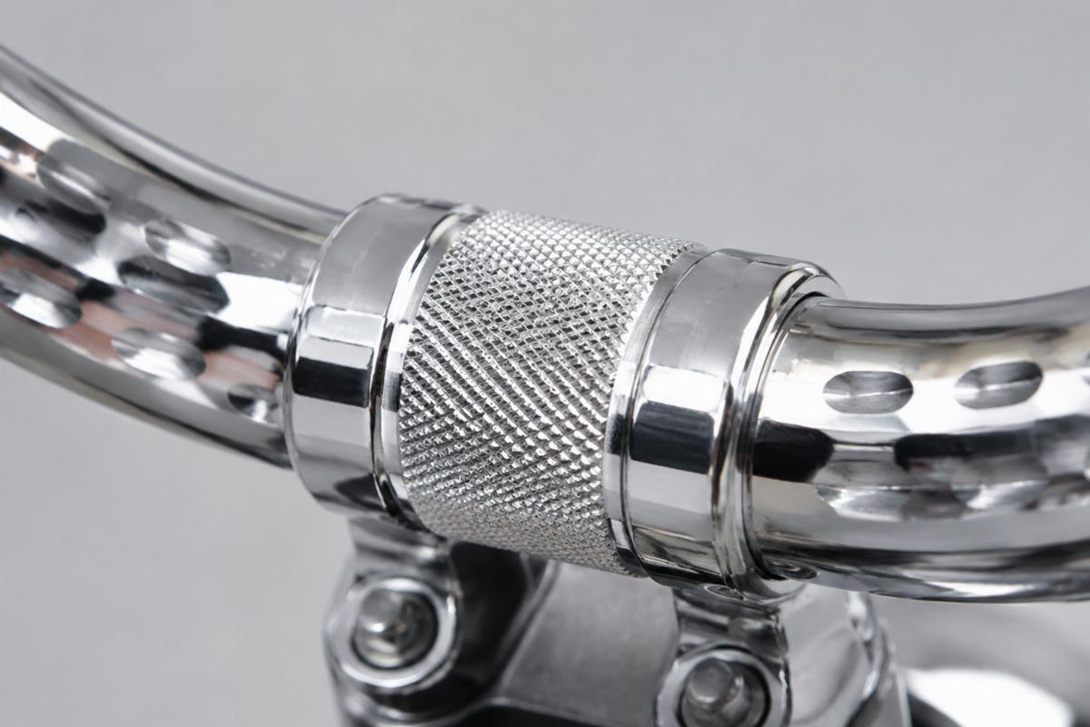 Close up of knurled riser area and dimpled slots on 1 1/4 inch chrome handlebars