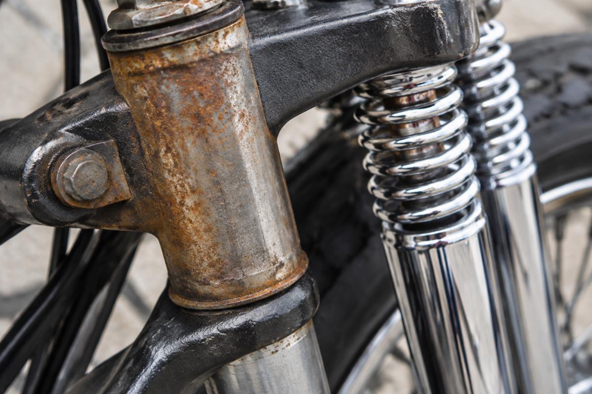Close up of the fork stem oxidation and chrome finish on the rear spring fork legs