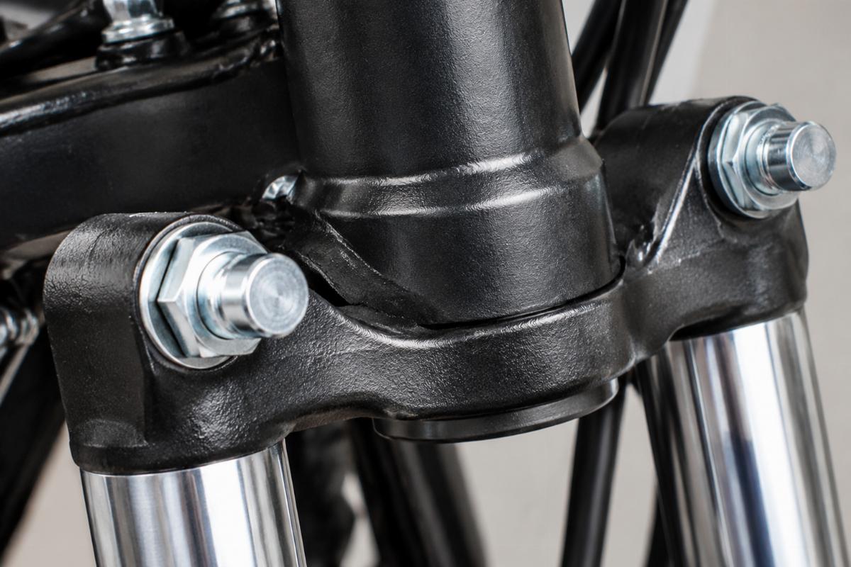 Close up of the larger bottom neck diameter and zinc plated rocker studs on the fork assembly