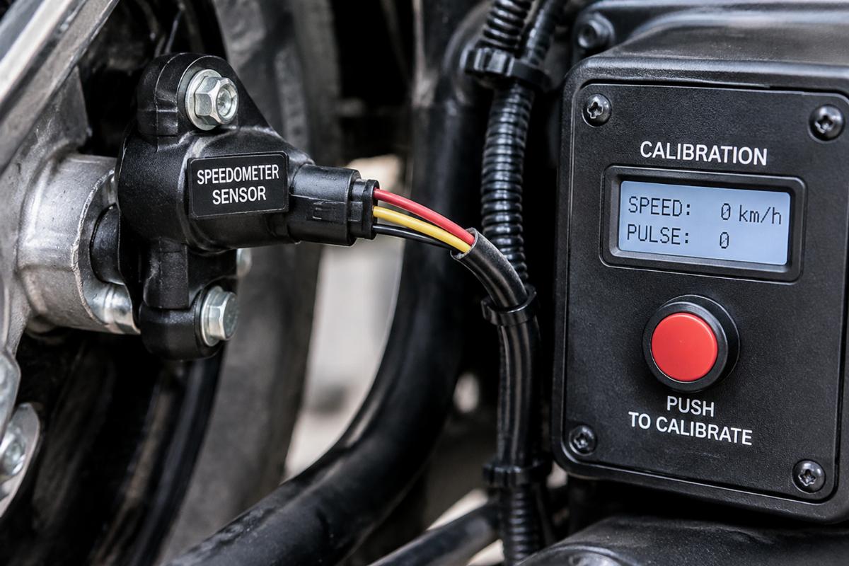 Close up of the speedometer sensor wiring and push button calibration interface