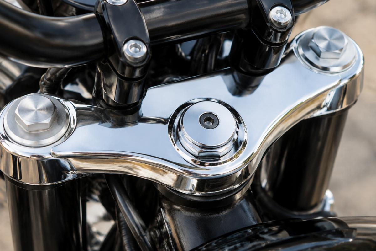 Close up of upper triple tree dust shield motorcycle aftermarket chrome finish