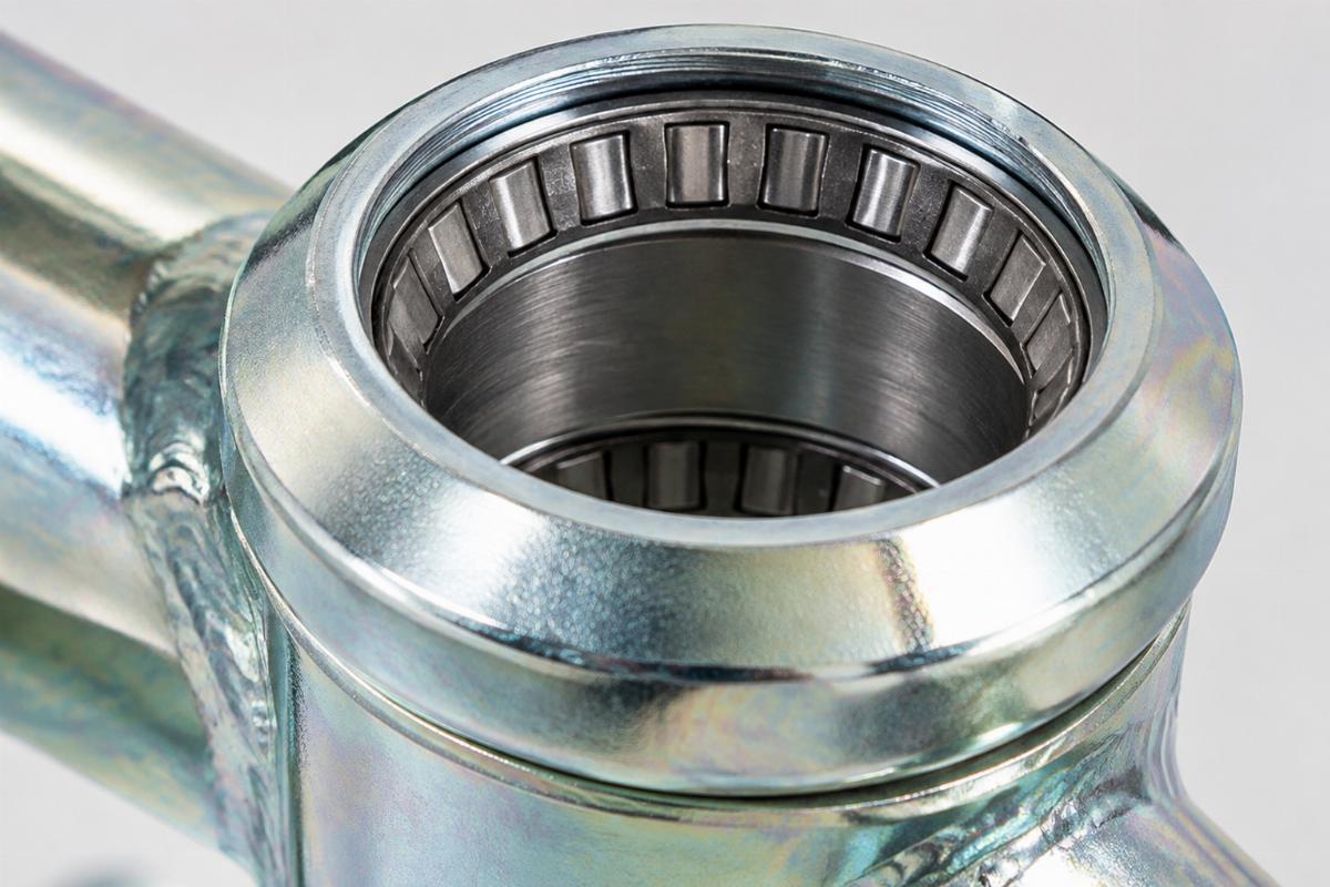 Close up of Zicad plated neck cup showing pressed in tapered bearing races
