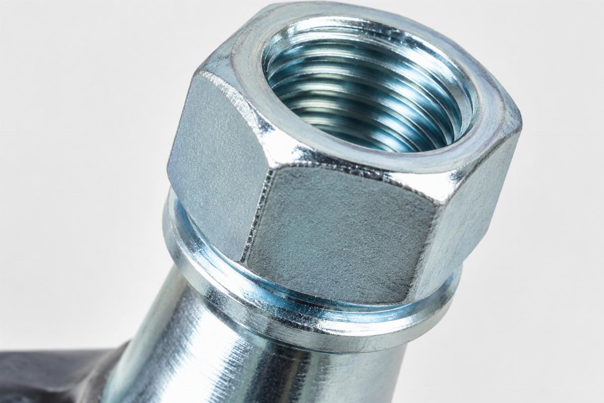 Close up of zinc plated spring fork stem hex nut motorcycle aftermarket thread and plating texture