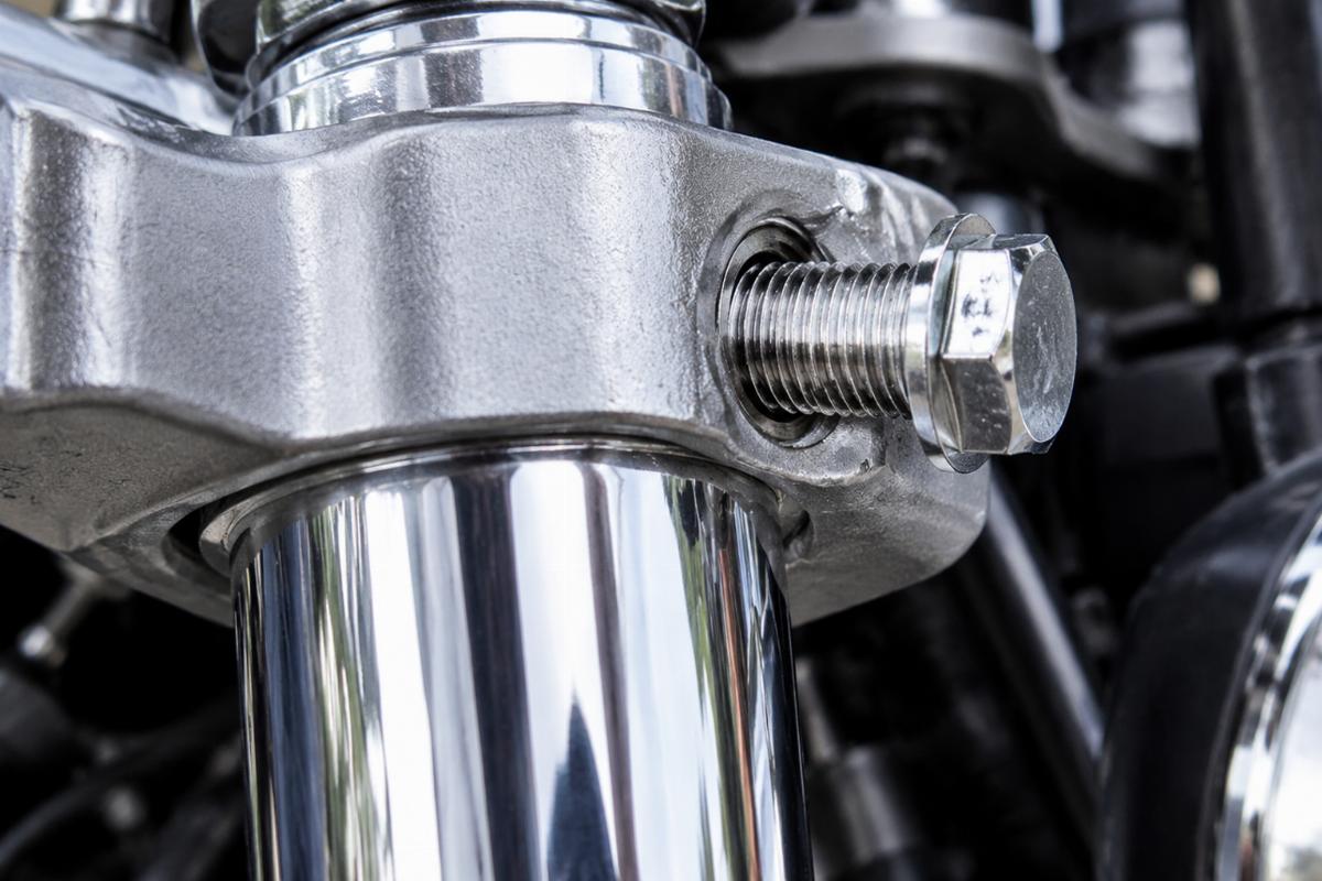 Detailed view of chrome plated fork tube upper bracket bolt threading
