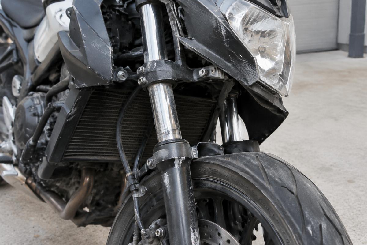 Photo of a returned motorcycle front end with visible signs of stress and misalignment